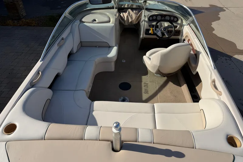 Slide: The Image of 1999 MasterCraft MariStar 210 VRS boat interior with beige seating and steering console. - 3