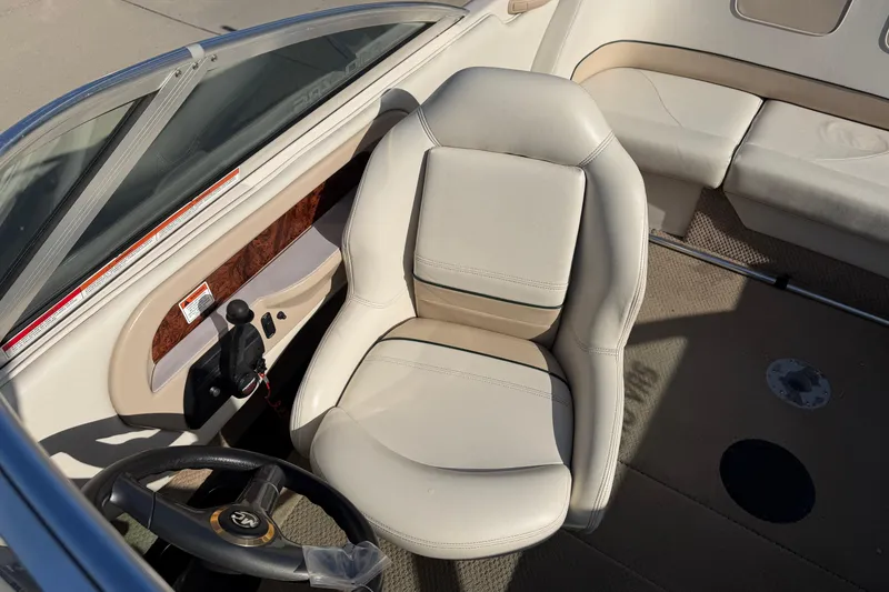 Slide: The Image of 1999 MasterCraft MariStar 210 VRS boat interior with beige captain's seat and steering wheel. - 5