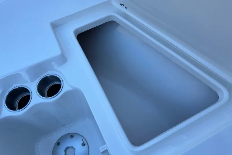 Slide: The Image of 2026 Key West 203 FS boat interior with cup holders and storage compartment. - 10