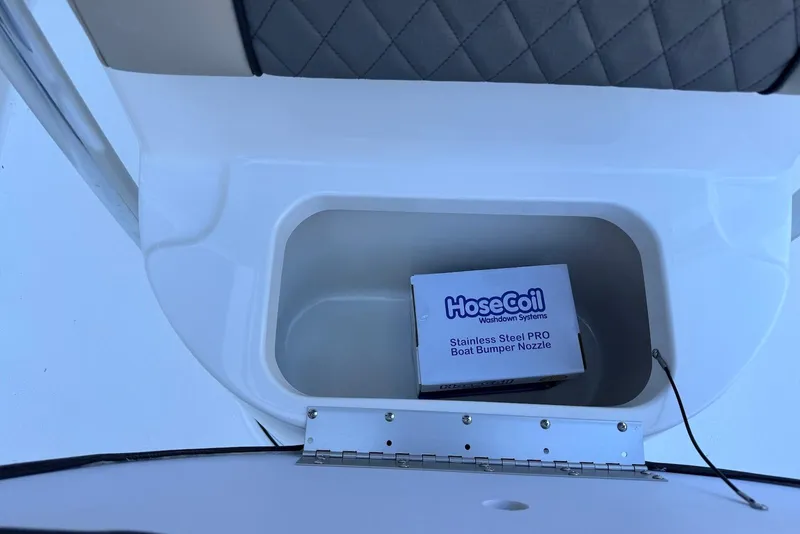 Slide: The Image of Storage compartment in 2026 Key West 203 FS boat with HoseCoil nozzle box. - 13
