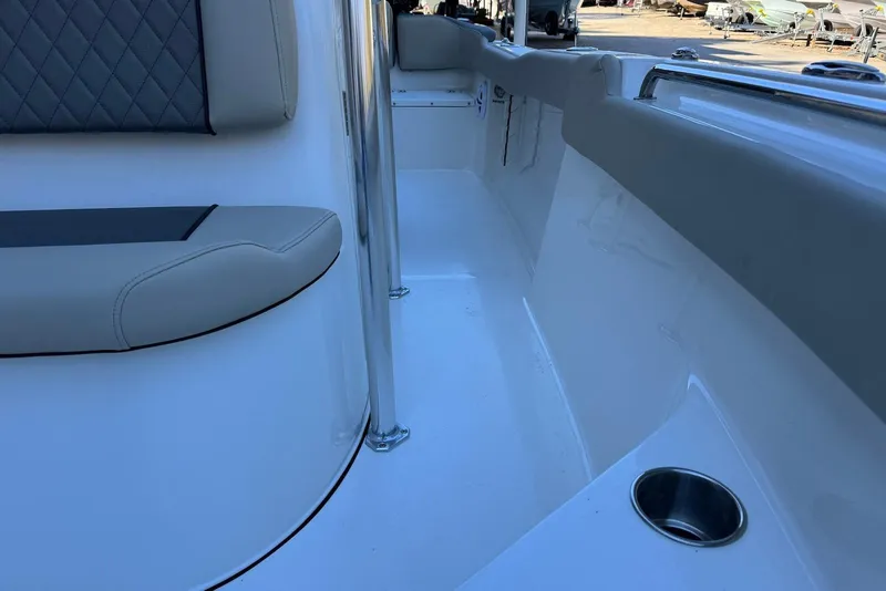 Slide: The Image of 2026 Key West 203 FS boat interior with cushioned seating and stainless steel cup holder. - 16
