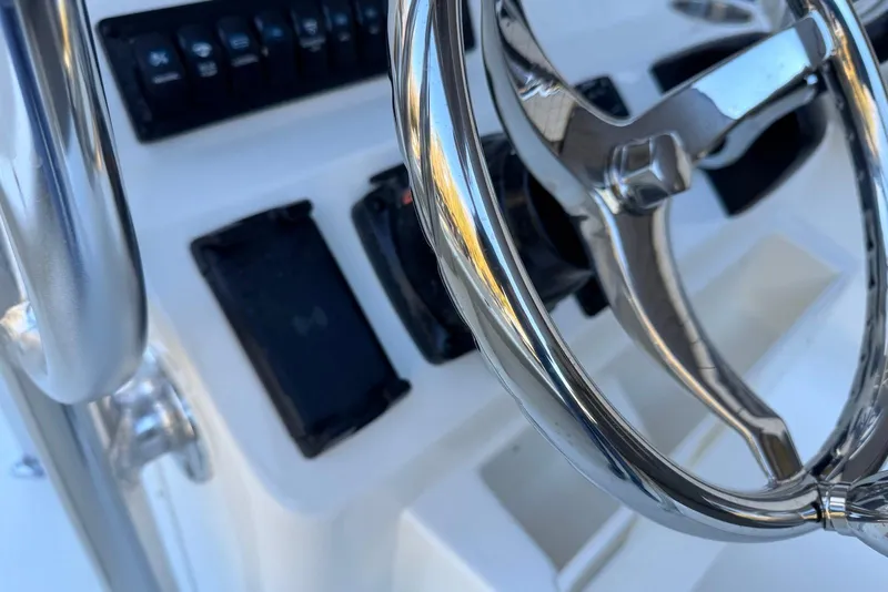 Slide: The Image of Steering wheel and controls of 2026 Key West 203 FS boat. - 18