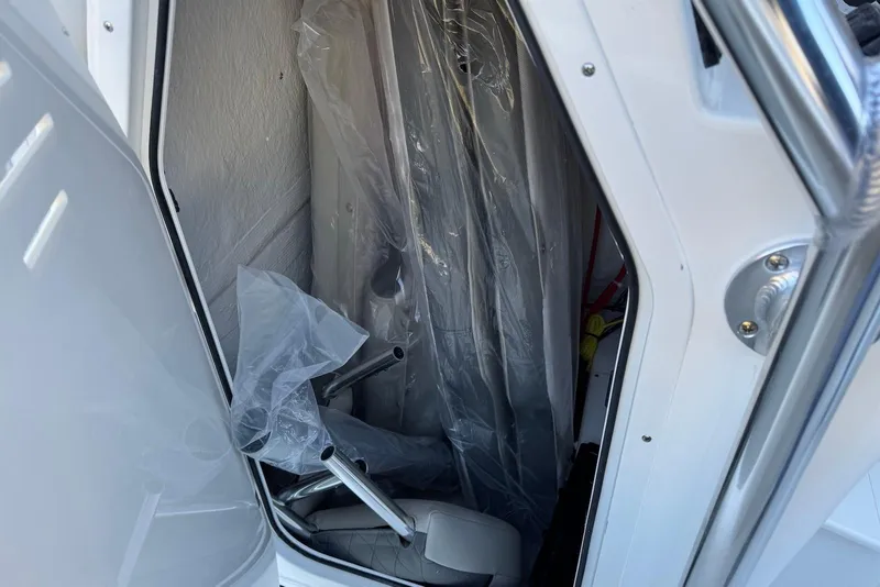 Slide: The Image of Interior storage compartment of 2026 Key West 203 FS boat, showing equipment and protective coverings. - 22