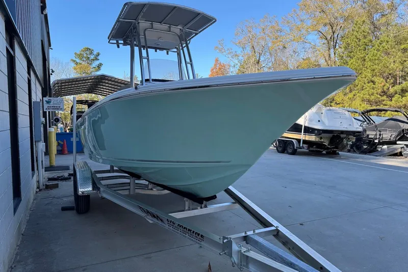 Slide: The Image of 2026 Key West 203 FS boat on trailer, parked outdoors near service entrance. - 5