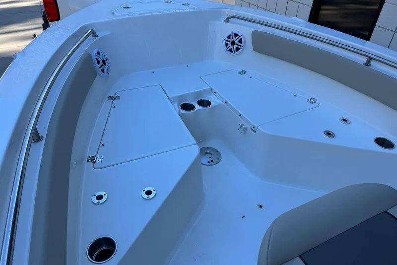 Slide: The Image of 2026 Key West 203 FS boat interior with seating, cup holders, and storage compartments. - 6