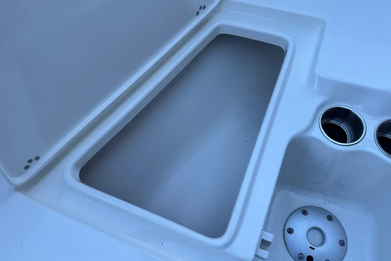 Slide: The Image of Open storage compartment on 2026 Key West 203 FS boat with cup holders. - 9