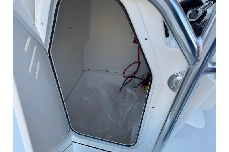 Slide: The Image of Open storage compartment on 2026 Key West 189 FS boat, showing interior space. - 13