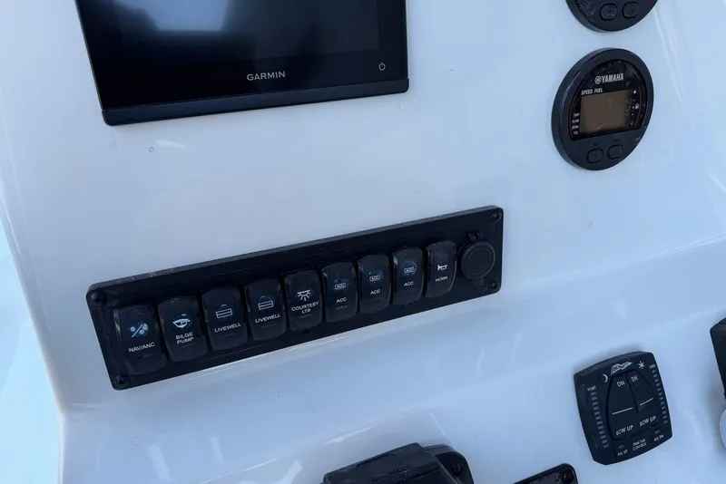 Slide: The Image of Control panel of 2026 Key West 189 FS boat with Garmin display and switches. - 15