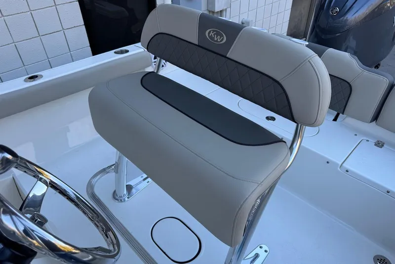 Slide: The Image of 2026 Key West 189 FS boat interior with sleek seating and steering wheel. - 17