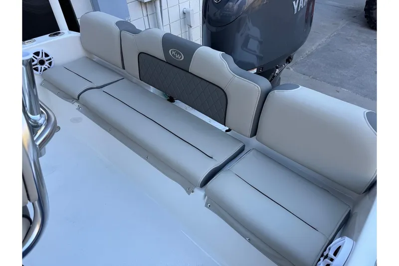 Slide: The Image of 2026 Key West 189 FS boat interior with gray cushioned seating and Yamaha engine. - 19