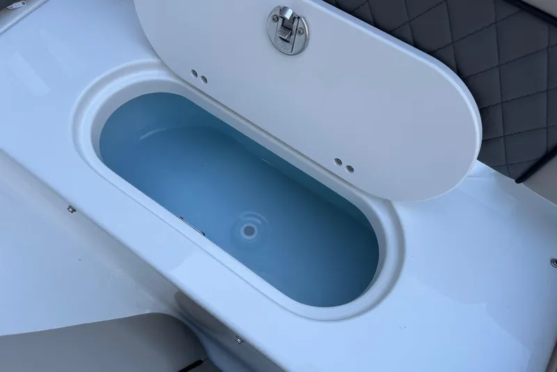Slide: The Image of Livewell compartment on 2026 Key West 189 FS boat, featuring a secure latch. - 20
