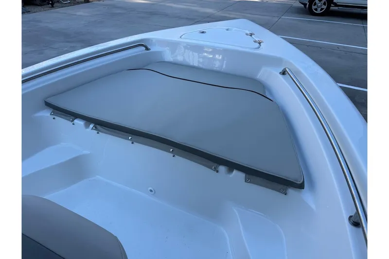 Slide: The Image of 2026 Key West 189 FS boat interior with cushioned seating and stainless steel railing. - 7