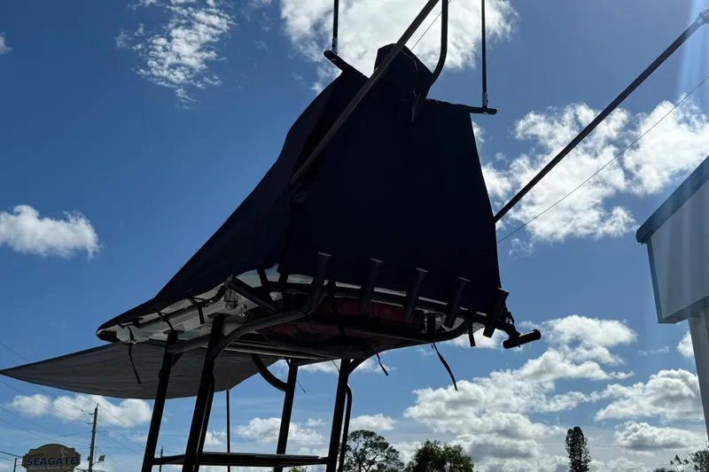 Slide: The Image of 2023 Caymas 28 HB Twin boat with covered tower against a cloudy sky. - 11