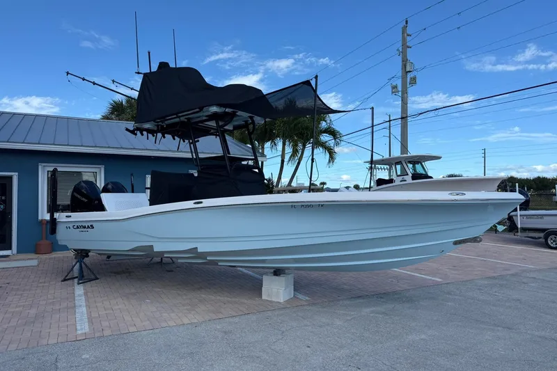 Slide: The Image of 2023 Caymas 28 HB Twin boat displayed outdoors on a stand. - 13