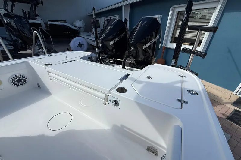 Slide: The Image of 2023 Caymas 28 HB Twin boat with dual Mercury engines, featuring a spacious deck. - 17