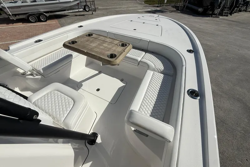 Slide: The Image of 2023 Caymas 28 HB Twin boat interior with white seating and wooden table. - 33