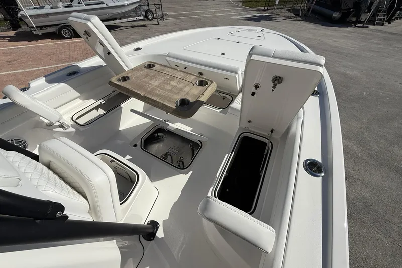 Slide: The Image of 2023 Caymas 28 HB Twin boat interior with seating, storage, and table setup. - 35