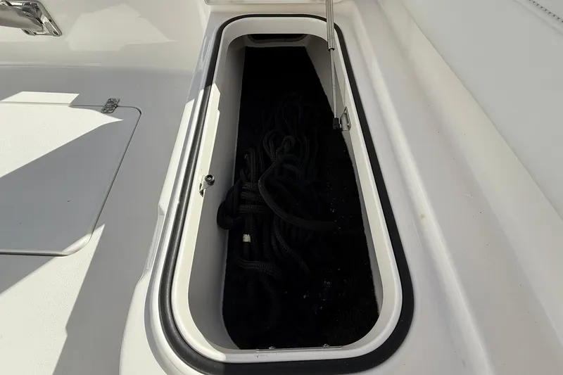 Slide: The Image of Storage compartment on 2023 Caymas 28 HB Twin boat, containing coiled rope. - 36