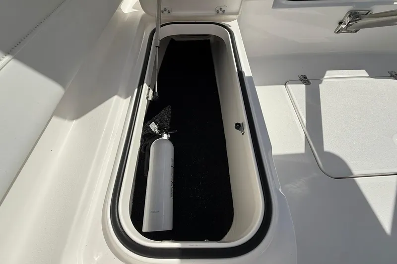Slide: The Image of Storage compartment with fire extinguisher on 2023 Caymas 28 HB Twin boat. - 37