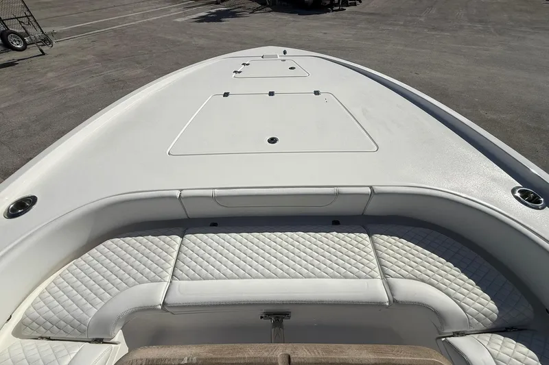 Slide: The Image of 2023 Caymas 28 HB Twin boat with white cushioned seating and storage compartments. - 39