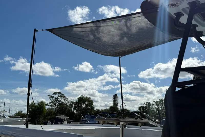 Slide: The Image of 2023 Caymas 28 HB Twin boat with sunshade under a clear blue sky. - 4