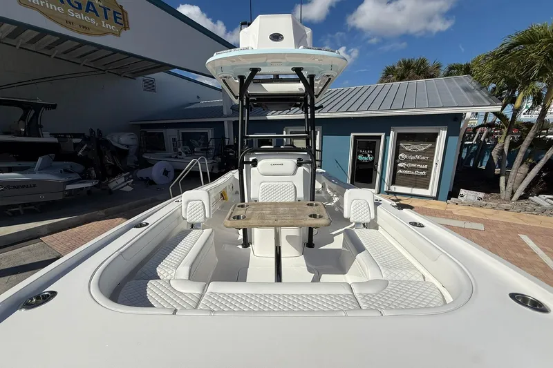 Slide: The Image of 2023 Caymas 28 HB Twin boat at a marina, showcasing seating and helm. - 41