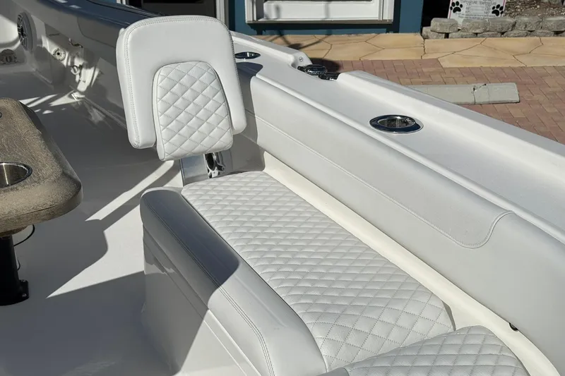 Slide: The Image of 2023 Caymas 28 HB Twin boat interior with white quilted seating and cup holders. - 42