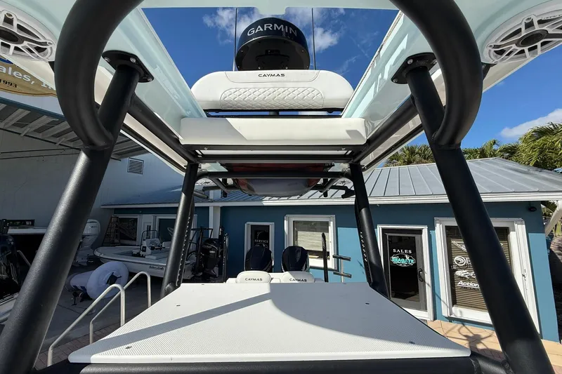 Slide: The Image of 2023 Caymas 28 HB Twin boat with Garmin equipment, docked near a blue building. - 46