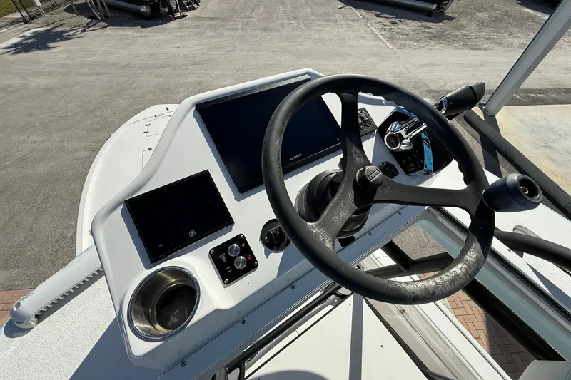 Slide: The Image of Helm of 2023 Caymas 28 HB Twin boat with steering wheel and controls. - 48