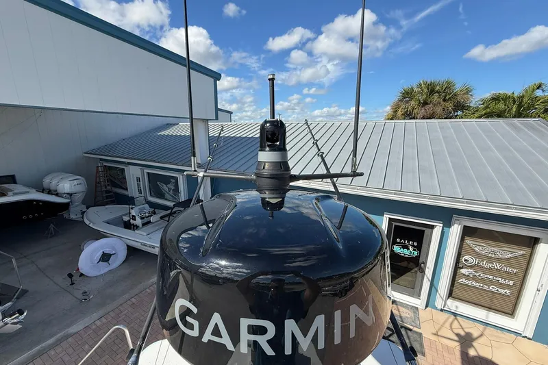 Slide: The Image of 2023 Caymas 28 HB Twin boat with Garmin radar, docked near a sales office. - 49