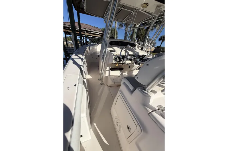 Slide: The Image of 2005 Grady-White Bimini 306 boat interior with steering wheel and seating. - 12