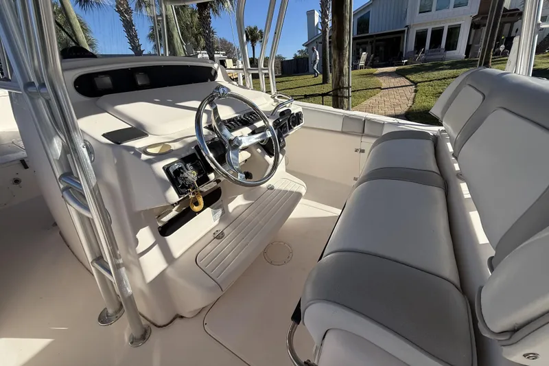 Slide: The Image of 2005 Grady-White Bimini 306 boat interior with steering wheel and seating. - 13