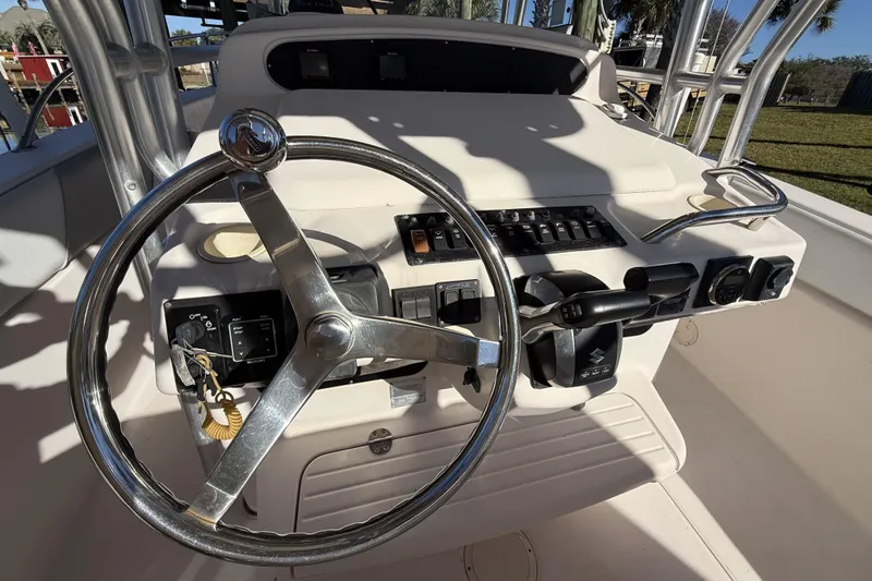Slide: The Image of 2005 Grady-White Bimini 306 boat helm with steering wheel and control panel. - 15