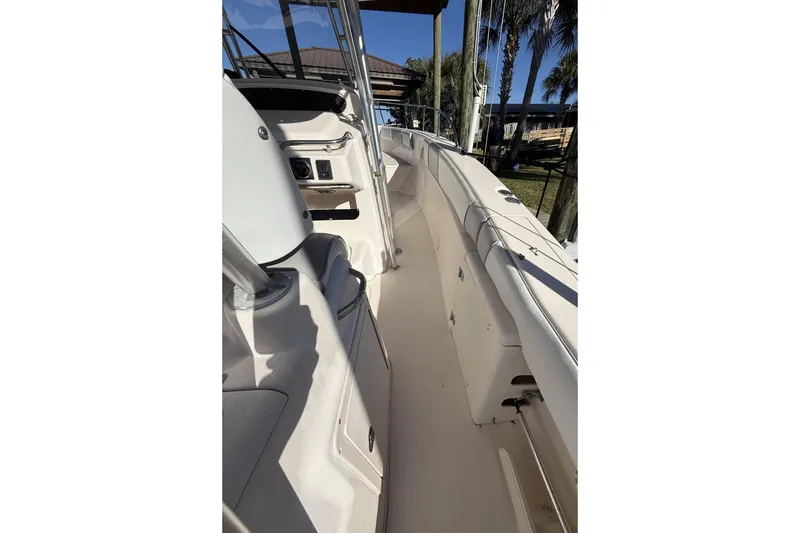 Slide: The Image of 2005 Grady-White Bimini 306 boat interior, showcasing helm and seating area. - 17