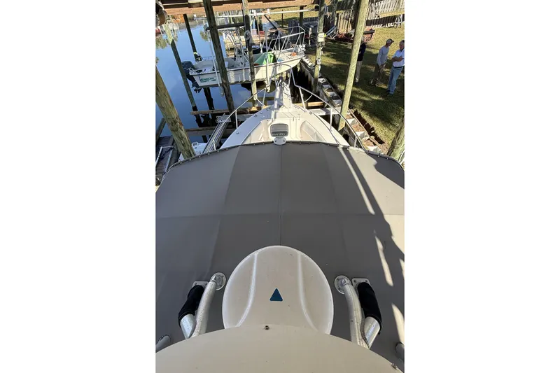 Slide: The Image of 2005 Grady-White Bimini 306 boat docked, viewed from above, with surrounding marina. - 2