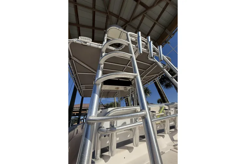 Slide: The Image of 2005 Grady-White Bimini 306 boat with metal ladder and canopy under a roof. - 7