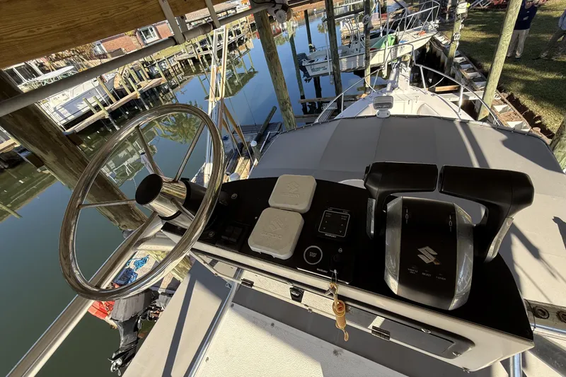 Slide: The Image of 2005 Grady-White Bimini 306 boat helm with steering wheel and controls, docked at marina. - 8