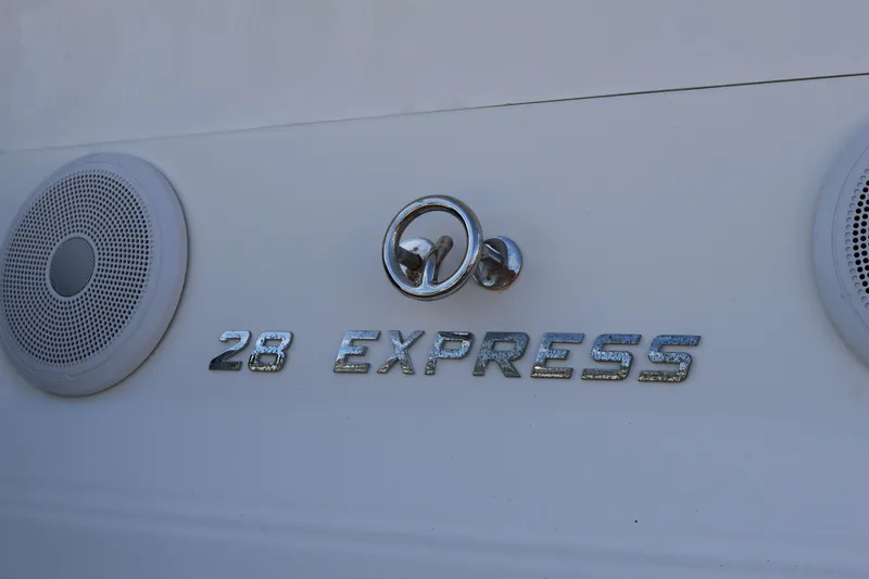 Slide: The Image of 2018 Regal 28 Express boat emblem with speakers on white surface. - 10