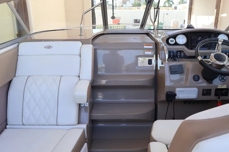 Slide: The Image of 2018 Regal 28 Express boat interior with steering wheel and seating area. - 15