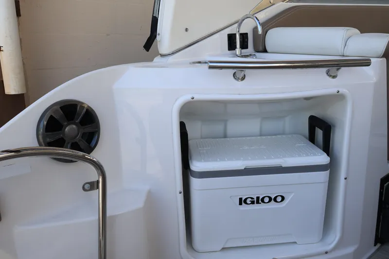Slide: The Image of 2018 Regal 28 Express boat interior with Igloo cooler and speaker. - 18