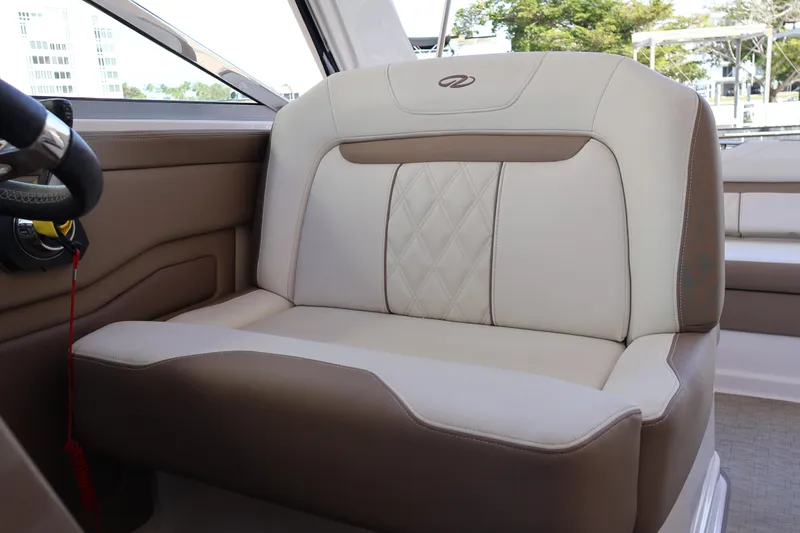 Slide: The Image of 2018 Regal 28 Express boat interior seat with beige and brown upholstery. - 24