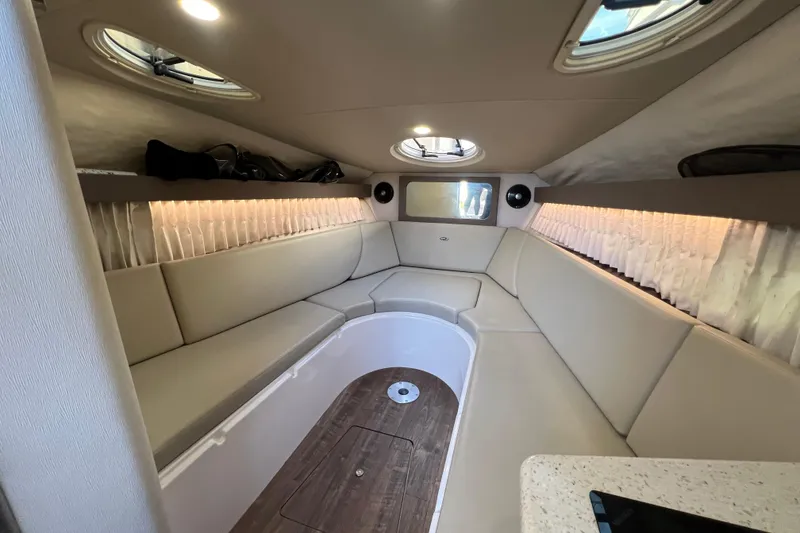 Slide: The Image of 2018 Regal 28 Express cabin interior with beige seating and wood flooring. - 27