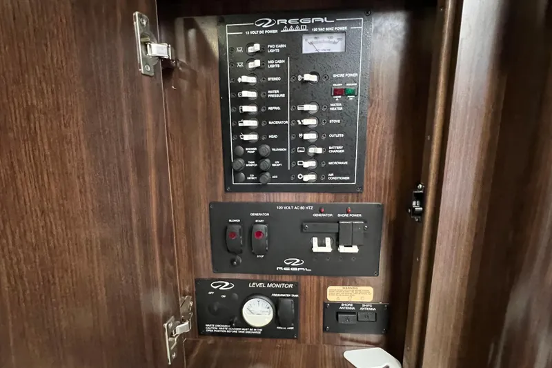 Slide: The Image of Control panel of a 2018 Regal 28 Express boat with various switches and indicators. - 36