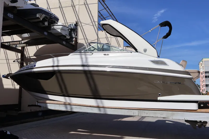 Slide: The Image of 2018 Regal 28 Express boat on lift, showcasing sleek design and modern features. - 4