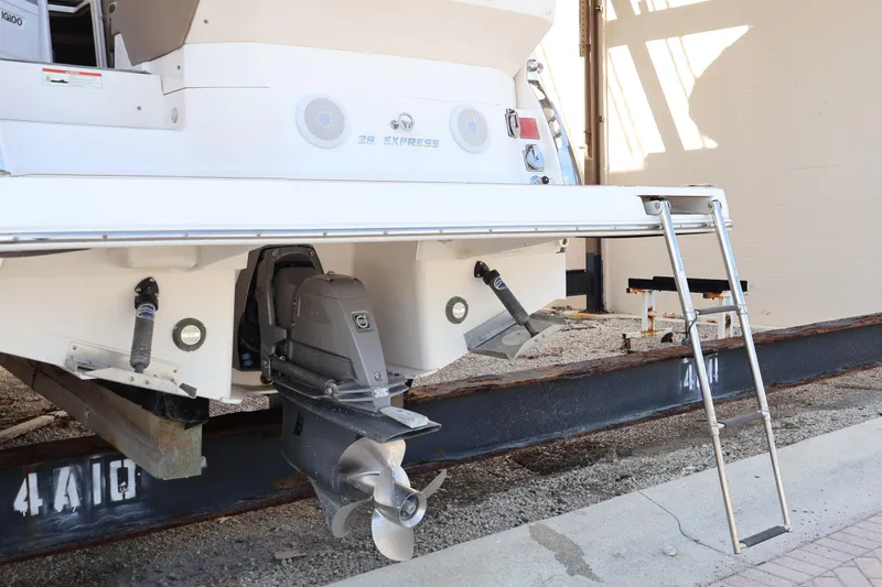 Slide: The Image of 2018 Regal 28 Express boat stern with propeller and ladder on display. - 7