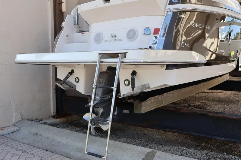 Slide: The Image of Rear view of 2018 Regal 28 Express boat with ladder and propeller. - 8