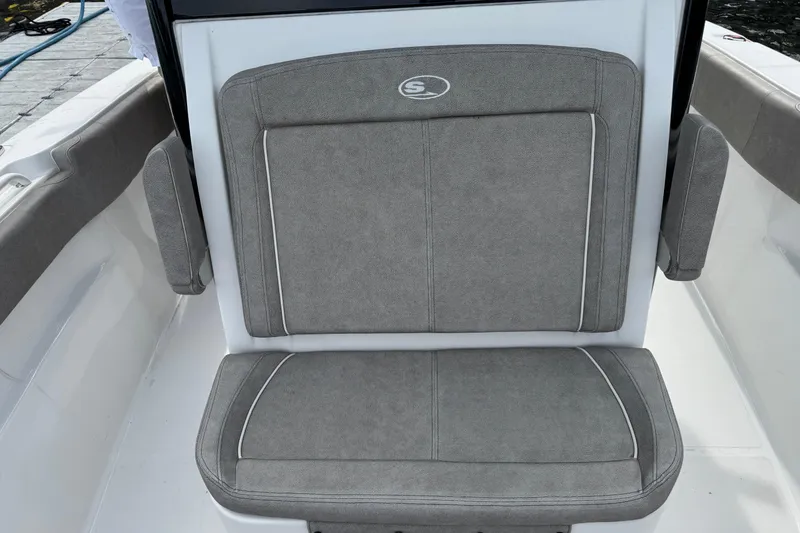 Slide: The Image of 2024 Sea Hunt Ultra 305 SE boat seat with gray upholstery and white accents. - 10