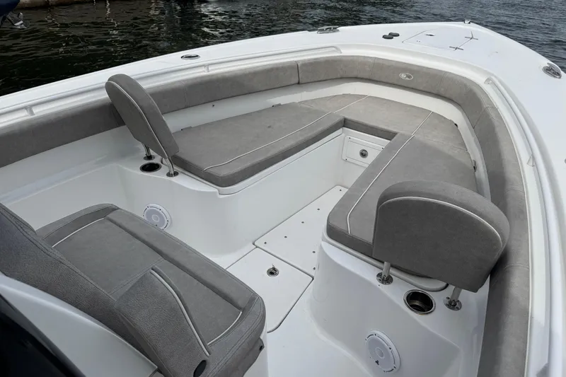 Slide: The Image of 2024 Sea Hunt Ultra 305 SE boat interior with gray cushioned seating and storage compartments. - 11