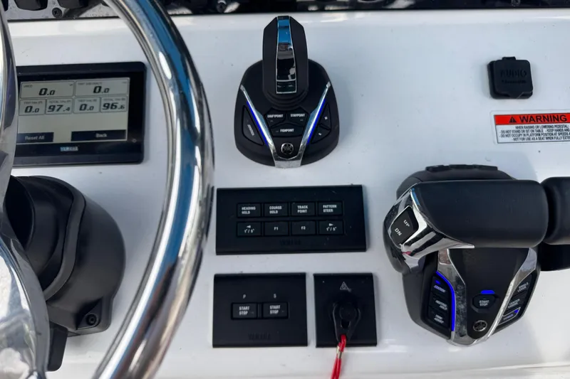 Slide: The Image of Control console of 2024 Sea Hunt Ultra 305 SE with controls. - 13