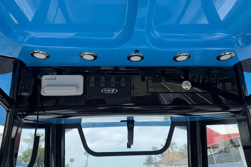 Slide: The Image of 2024 Sea Hunt Ultra 305 SE dashboard with Garmin electronics and overhead lighting. - 16